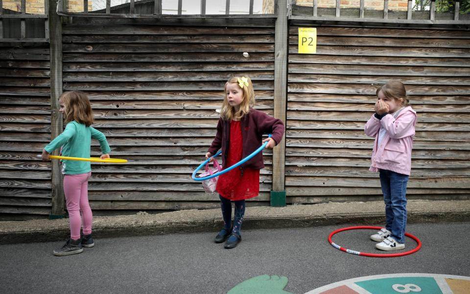 Children using hoops for social distancing at an independent London school - Reuters