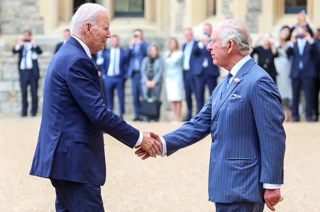 <p>CHRIS JACKSON/POOL/AFP via Getty Images</p> US President Joe Biden is greeted by Britain's King Charles III greets during a ceremonial welcome in the Quadrangle at Windsor Castle