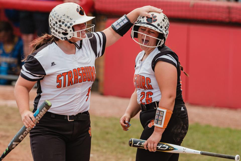 Strasburg's Emma Gilkerson, left, and Sydney Sibila celebrate their first run in the fourth inning during their Division 4 State Softball Championship game against Lincolnview Saturday, June 4 at Firestone Stadium in Akron.