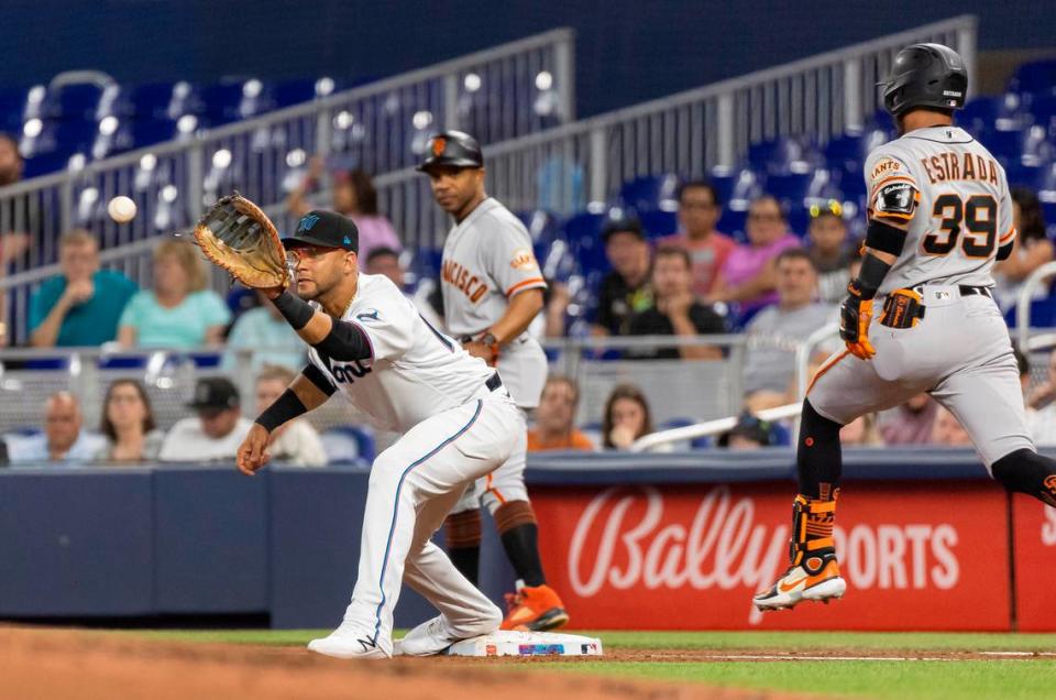 Miami Marlins first baseman Yuli Gurriel (10) tags San Francisco Giants second baseman Thairo Estrada (39) out after he hit a ground ball to third base in the third inning of an MLB game at loanDepot park on Monday, April 17, 2023, in Miami, Fla.