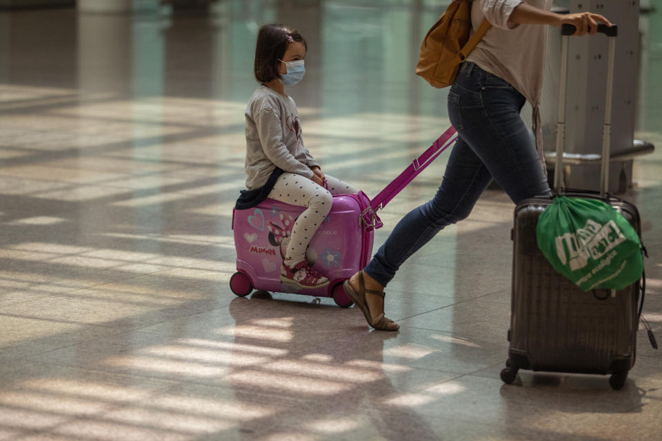 Passengers arrive at the Barcelona airport, Spain, Tuesday, June 30, 2020. The European Union on Tuesday is announcing a list of nations whose citizens will be allowed to enter 31 European countries. As Europe’s economies reel from the impact of the coronavirus, southern EU countries like Greece, Italy and Spain are desperate to entice back sun-loving visitors and breathe life into their damaged tourism industries. (AP Photo/Emilio Morenatti)