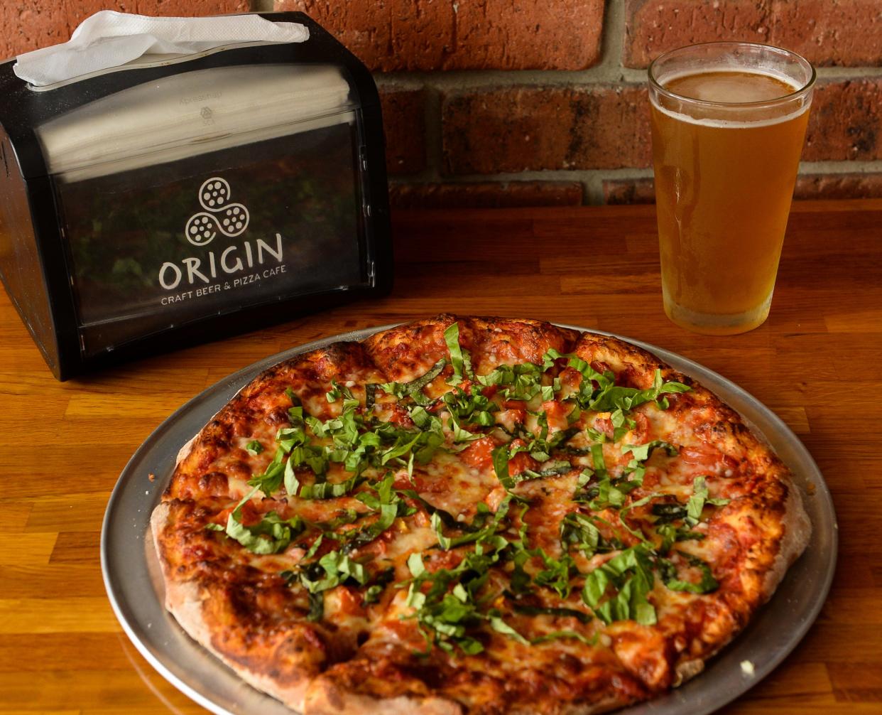 A Charlie’s Margherita Pizza is served at Origin Craft Beer & Pizza Cafe in Sarasota. Origin plans to open in The Landings later this summer at 4944 S. Tamiami Trail. It will be the locally owned restaurant's fourth location.