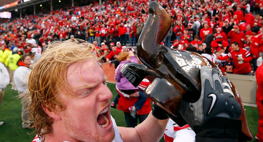 Ohio State offensive linesman Jack Mewhort (74) celebrates with the wooden turtle trophy named Illibuck after beating Illinois during an NCAA college football game on Saturday, Nov. 16, 2013, in Champaign, Ill.