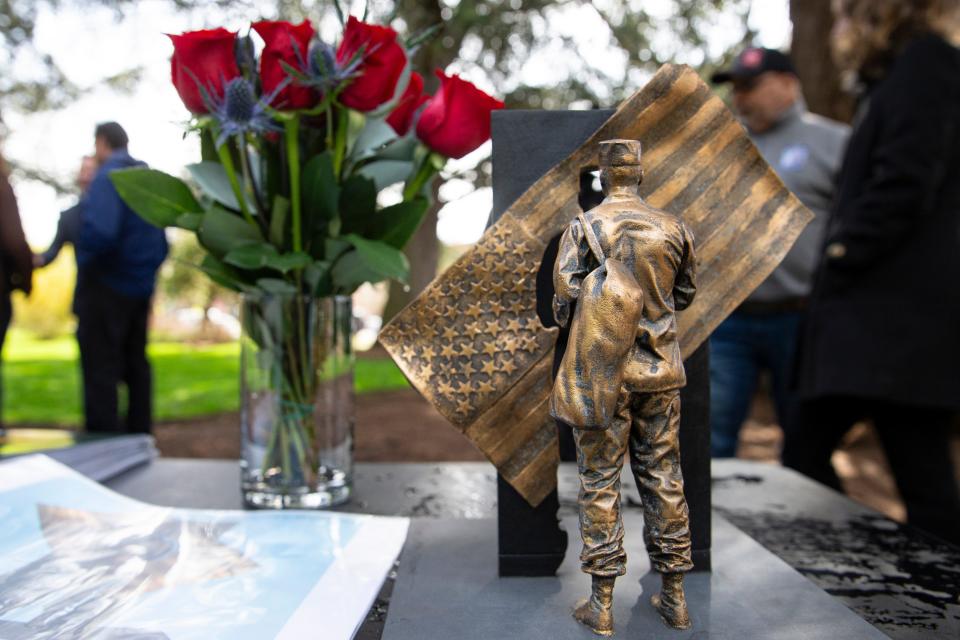 A miniature model of the bronze sculpture created by Portland artist Libby Carruth titled "A Solider's Return." It's in addition to the engraved granite columns.