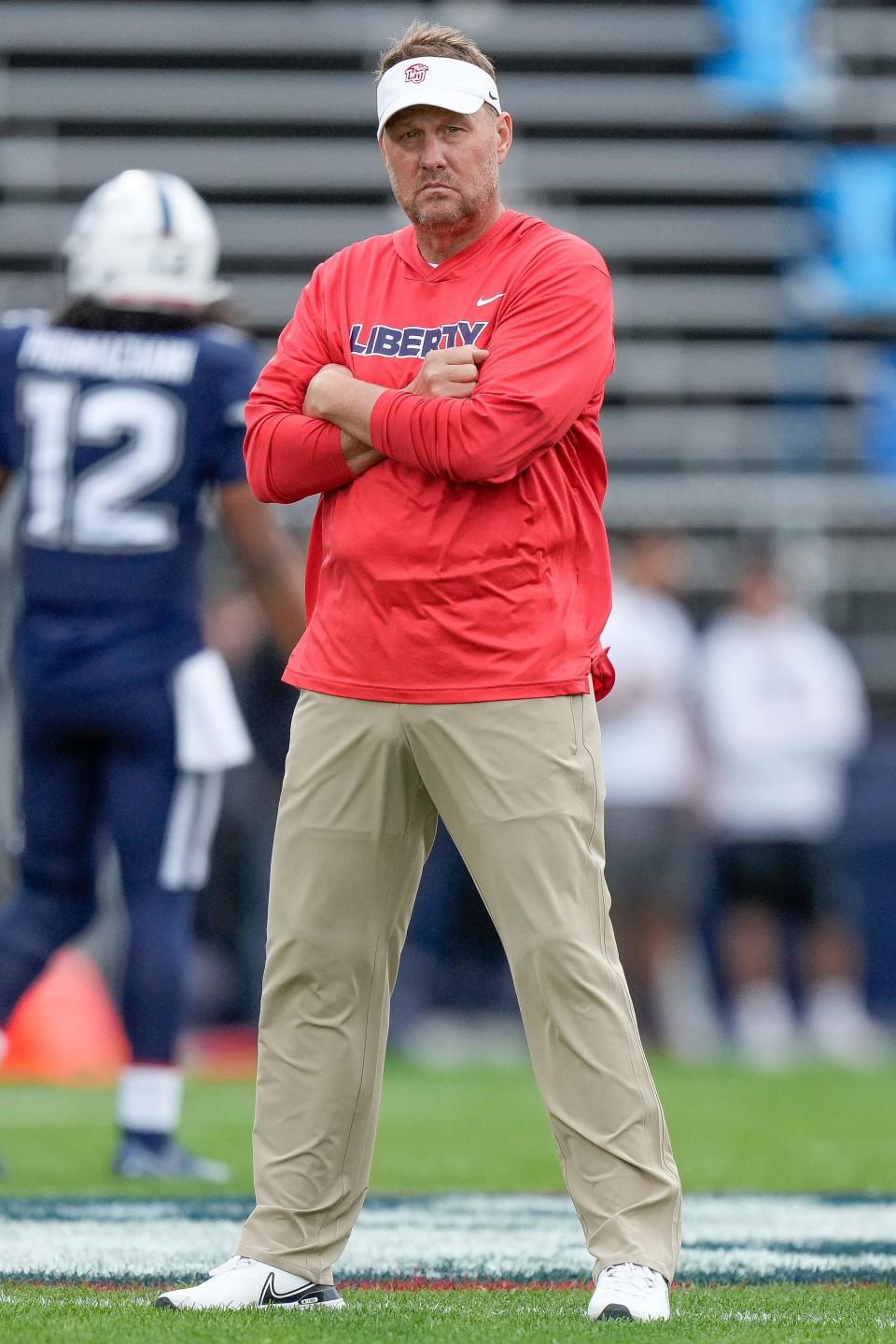 Liberty head coach Hugh Freeze watches warm up prior to an NCAA college football game against Connecticut in East Hartford, Conn., Saturday, Nov. 12, 2022. (AP Photo/Bryan Woolston)