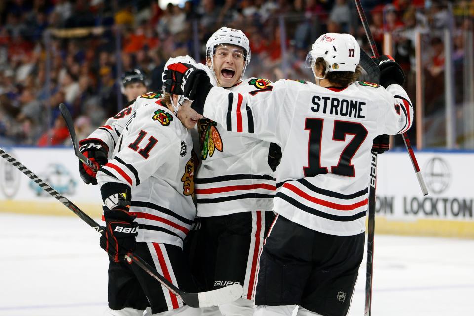 Chicago Blackhawks forward Colton Dach, center, celebrates a goal with Adam Gaudette (11) and Dylan Strome (17) during the first period of a preseason NHL hockey game against the St. Louis Blues in Independence, Mo., Saturday, Oct. 2, 2021. (AP Photo/Colin E. Braley)