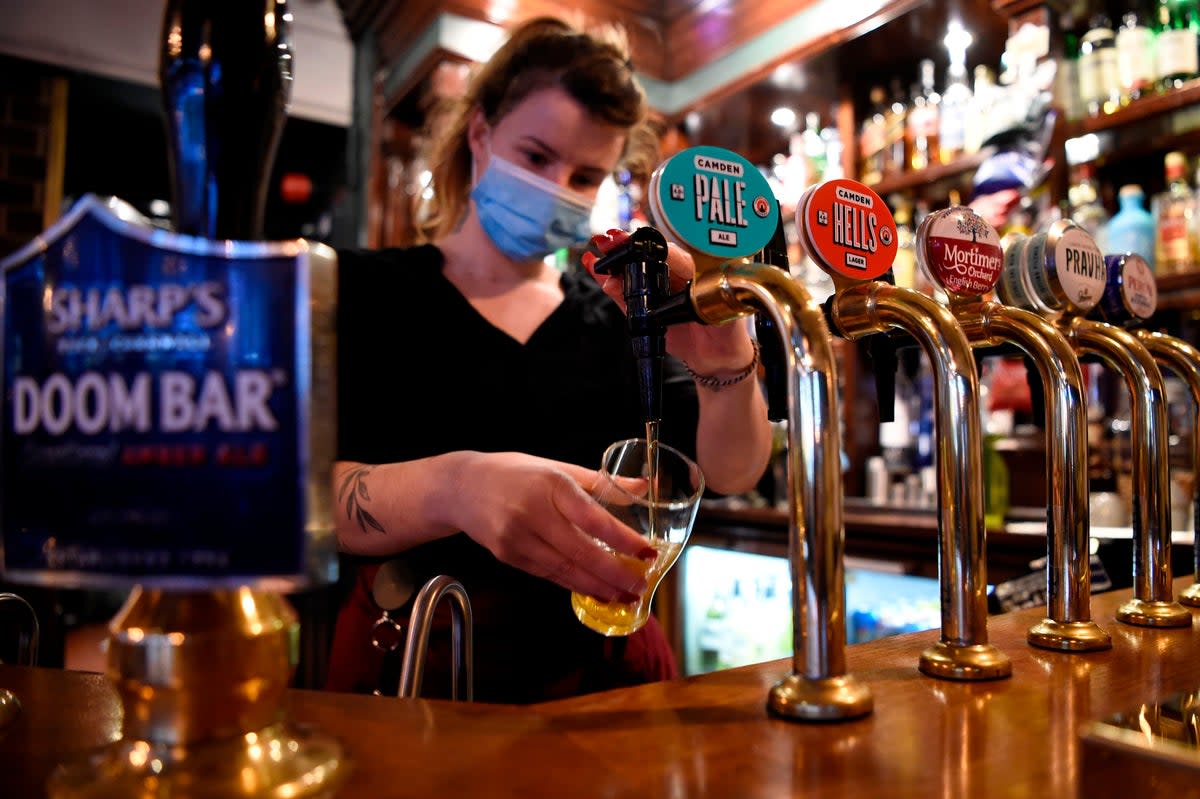 A server pours a pint of Camden Pale Ale inside a pub in Mayfair on November 3, 2020 (AFP via Getty Images)