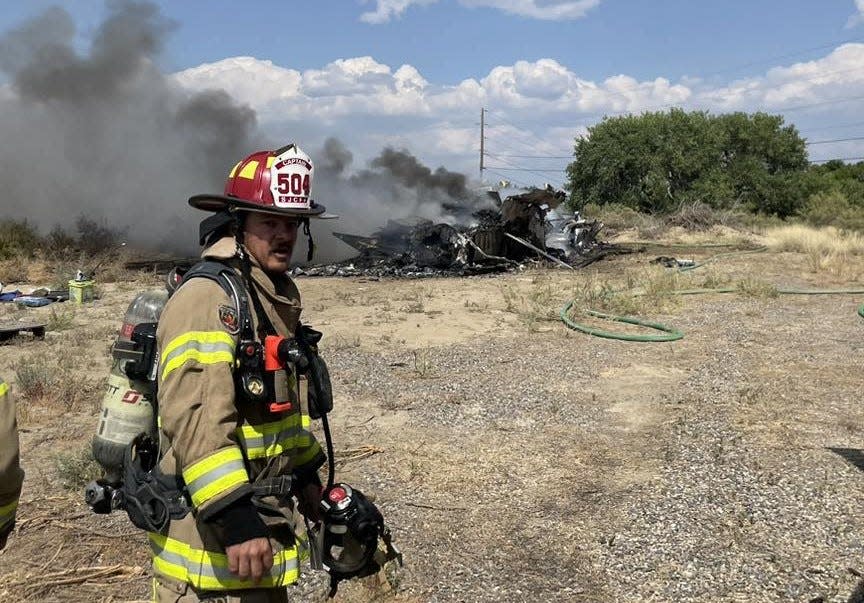 A San Juan County firefighter is pictured at the scene of an Aug. 22 RV blaze in the Blanco area. The department will add several new firefighters in the months ahead under a plan approved earlier this week by the San Juan County Commission.
