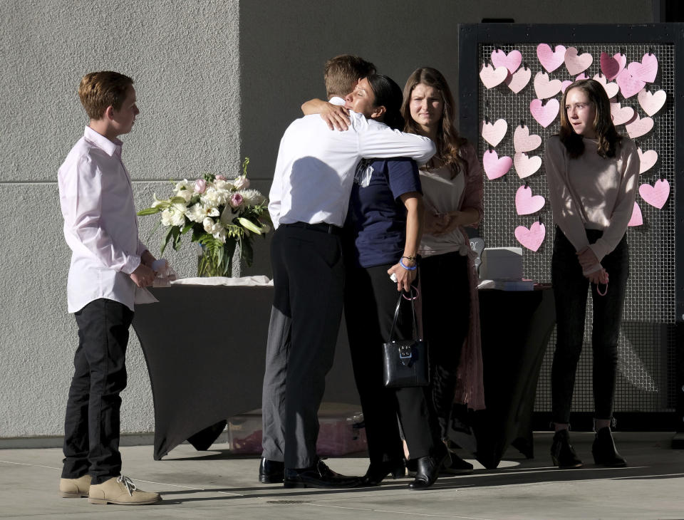 Mourners hug following the memorial service to celebrate the life of 15-year-old Gracie Anne Muehlberger, at Real Life Church, Saturday, Nov. 23, 2019, in Valencia, Calif. Muehlberger was one of two students killed Nov. 14, 2019, in the shooting at Saugus High School. (Dean Musgrove/The Orange County Register/SCNG via AP)