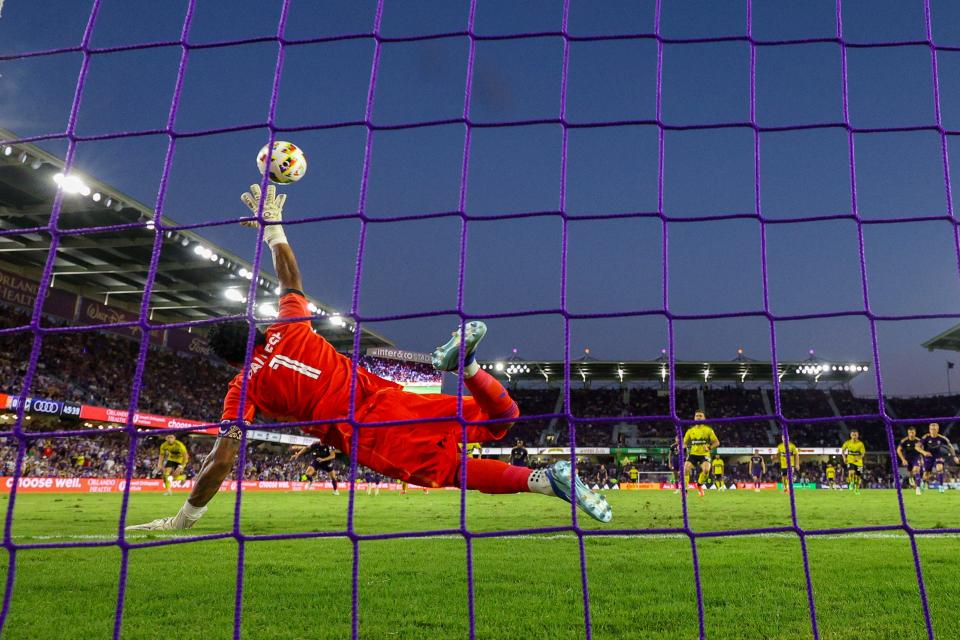 Crew forward Diego Rossi scores on a penalty kick past Orlando City goalkeeper Pedro Gallese.