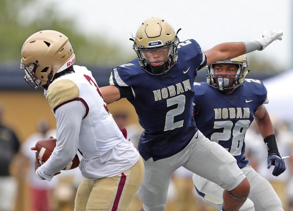 Hoban safety Jayvian Crable looks to sack Iona Prep quarterback Aiani Sheppard during the second half of a high school football game, Saturday, Sept. 3, 2022, in Akron, Ohio.