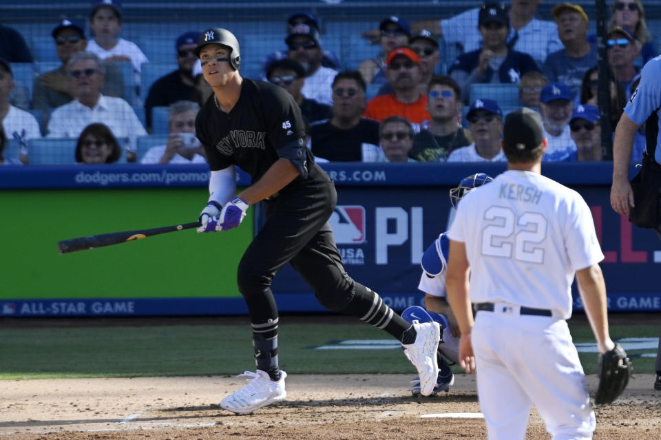 New York Yankees' Aaron Judge, left, runs to first as he hits a solo home run as Los Angeles Dodgers starting pitcher Clayton Kershaw watches during the third inning of a baseball game Sunday, Aug. 25, 2019, in Los Angeles. (AP Photo/Mark J. Terrill)