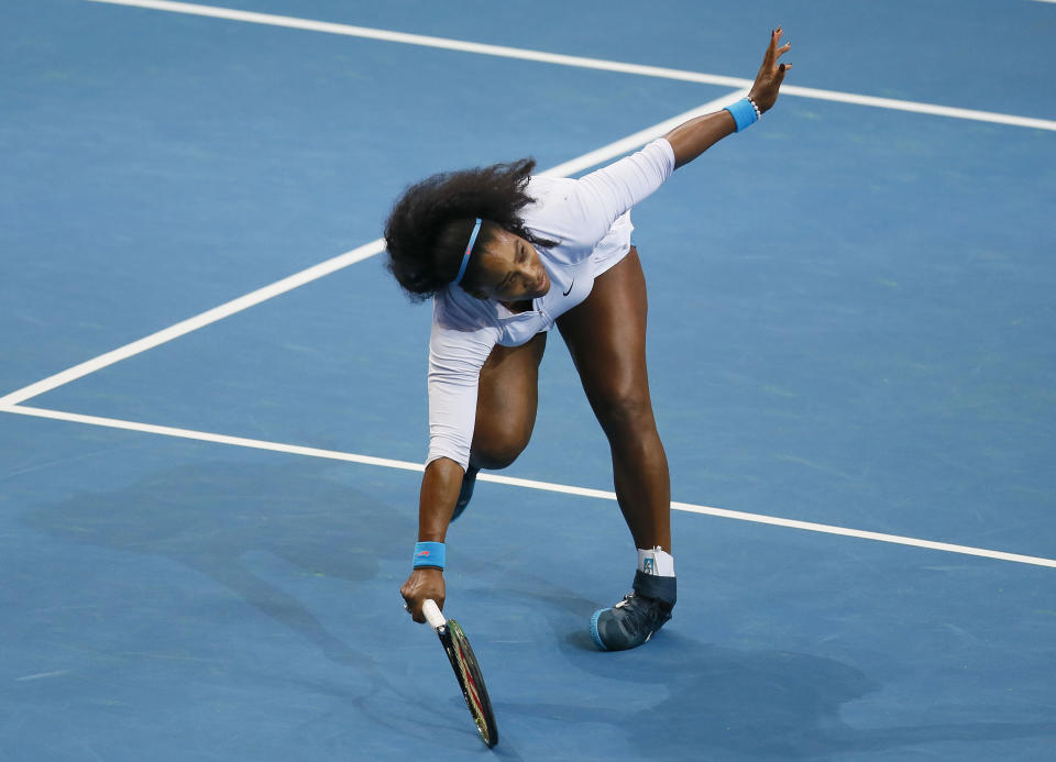 File-This Dec. 7, 2015, file photo shows USA's Serena Williams tripping as she returns a shot to Croatia's Mirjana Lucic-Baroni of Japan Warriors in the women's singles match of the 2015 International Premier Tennis League at suburban Pasay city south of Manila, Philippines. Williams has been voted the AP Female Athlete of the Decade for 2010 to 2019. Williams won 12 of her professional-era record 23 Grand Slam singles titles over the past 10 years. No other woman won more than three in that span. She also tied a record for most consecutive weeks ranked No. 1 and collected a tour-leading 37 titles in all during the decade. Gymnast Simone Biles finished second in the vote by AP member sports editors and AP beat writers. Swimmer Katie Ledecky was third, followed by ski racers Lindsey Vonn and Mikaela Shiffrin. (AP Photo/Bullit Marquez, File)