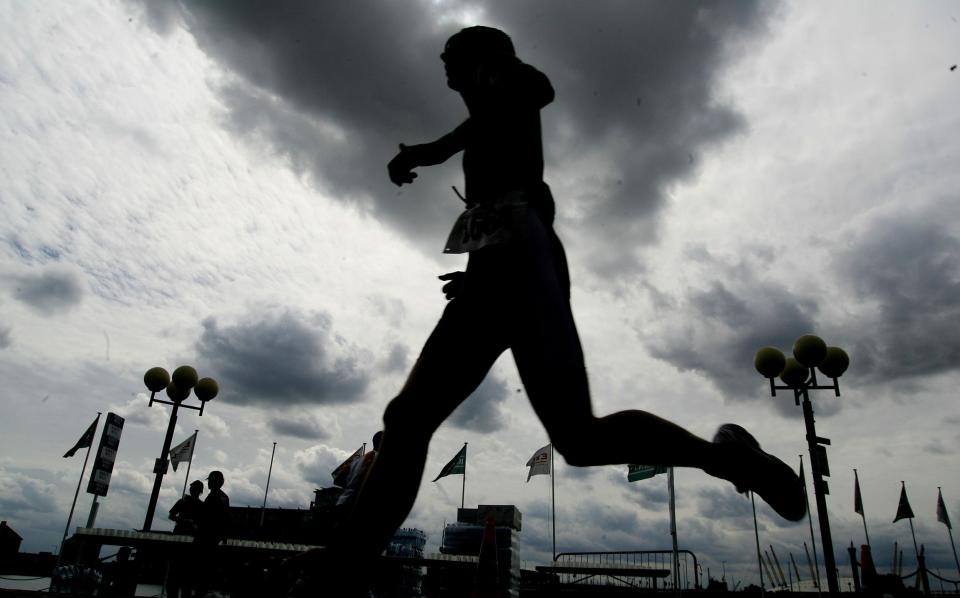 Silhouette of runner during london triathlon at London's Docklands - British Triathlon to ban transgender women competing against females - ACTION IMAGES