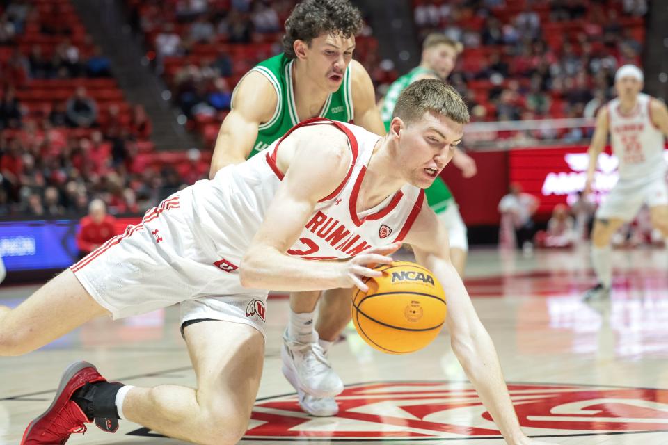 Utah Utes center Lawson Lovering (34) dives for the ball but is charged with a traveling violation during the game against the Utah Valley Wolverines at the Huntsman Center in Salt Lake City on Saturday, Dec. 16, 2023. | Spenser Heaps, Deseret News