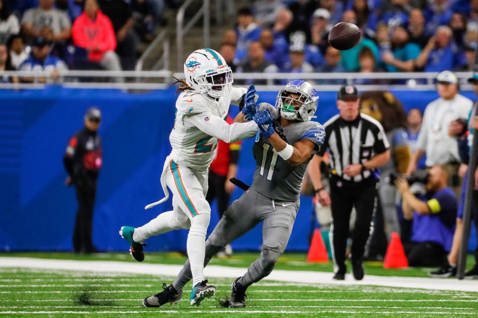 Miami Dolphins cornerback Keion Crossen (27) hits Detroit Lions wide receiver Josh Reynolds (8) as he tries to make a catch during the second half at Ford Field in Detroit on Sunday, Oct. 30, 2022.