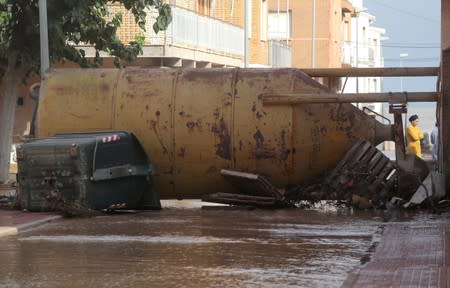 A tank blocks a flooded street after heavy rains in Los Alcazeres