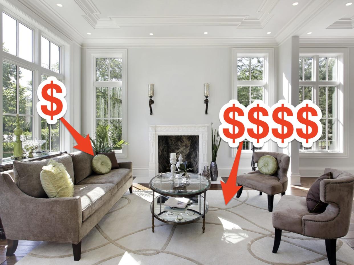 Living room with a couch with throw pillows and a large cream rug. An arrow with "$" points to the throw pillows and an arrow with "$$$$" points to the rug.