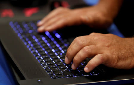 FILE PHOTO: A man types into a keyboard during the Def Con hacker convention in Las Vegas, Nevada, U.S. July 29, 2017. REUTERS/Steve Marcus/File Photo