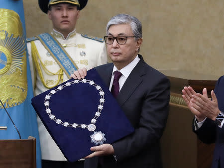 FILE PHOTO: Acting President of Kazakhstan Kassym-Jomart Tokayev takes part in a swearing-in ceremony during a joint session of the houses of parliament in Astana, Kazakhstan March 20, 2019. REUTERS/Mukhtar Kholdorbekov/File Photo
