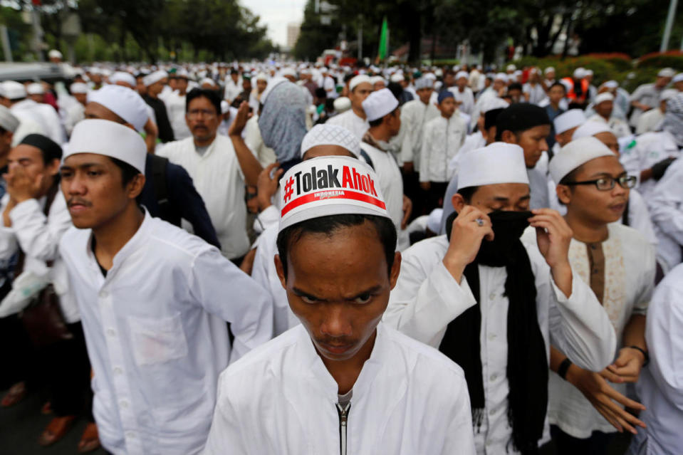 <p>Hard-line Muslim groups block a street during a protest against Jakarta’s incumbent governor, Basuki Tjahaja Purnama (Ahok), an ethnic Chinese Christian running in the upcoming election, in Jakarta, Indonesia, Oct. 14, 2016. The sign reads: “Reject Ahok.” (Photo: Beawiharta/Reuters)</p>