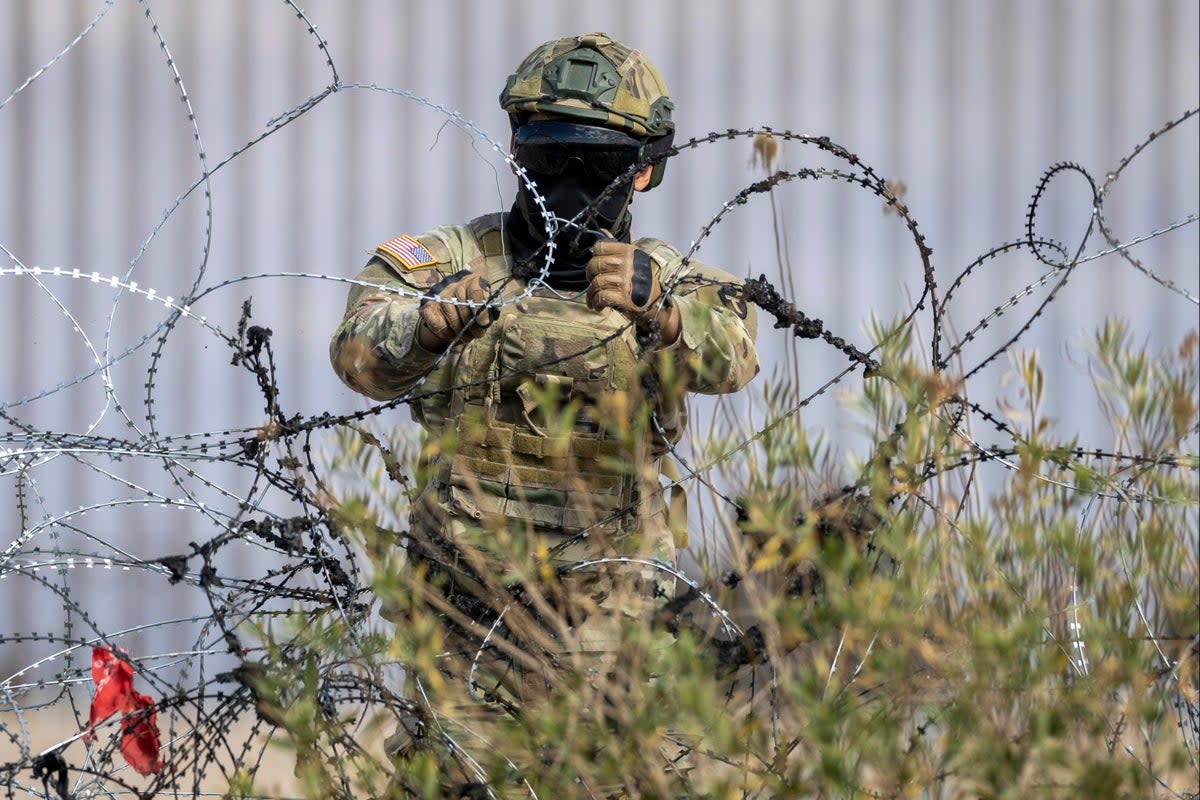 A Texas National Guard soldier puts up additional razor wire at the U.S.-Mexico border in El Paso, Texas on January 31, 2024 across from Ciudad Juarez, Mexico (Getty Images)