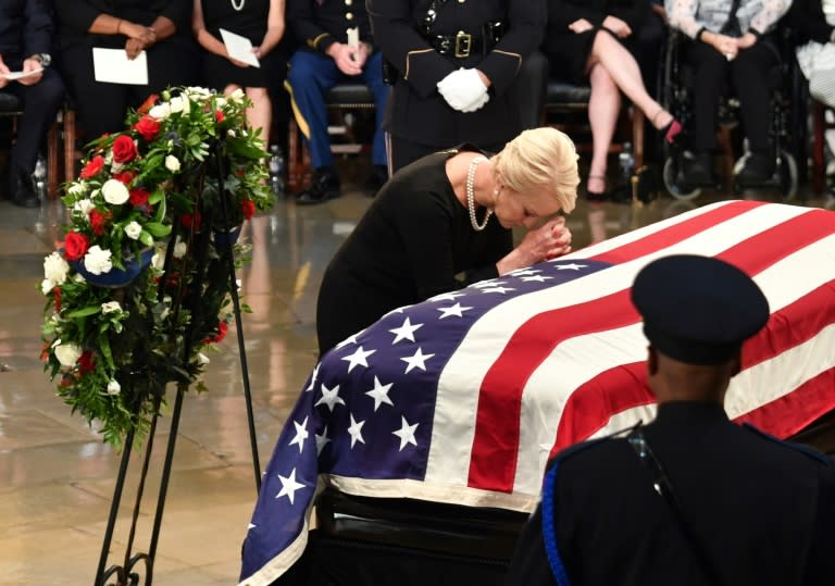 Cindy McCain, wife of John McCain, prays at the casket of her husband at the US Capitol Rotunda in Washington