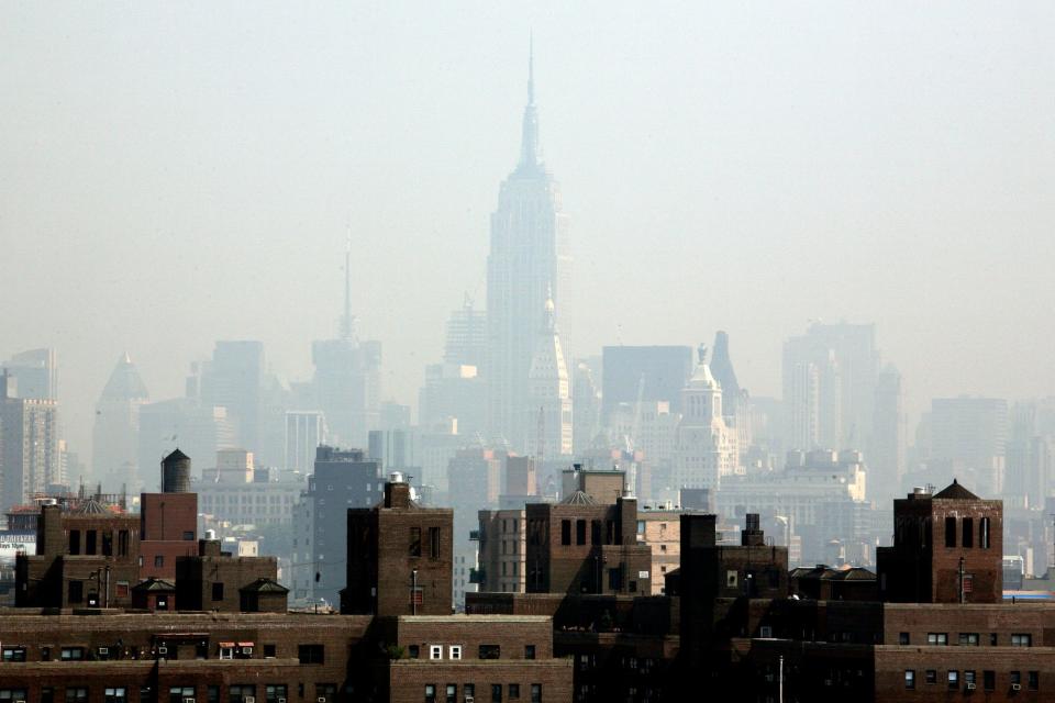 Smog covers midtown Manhattan in New York on Tuesday, July 10, 2007. By 2080, the climate of New York will be similar to that of Arkansas today.