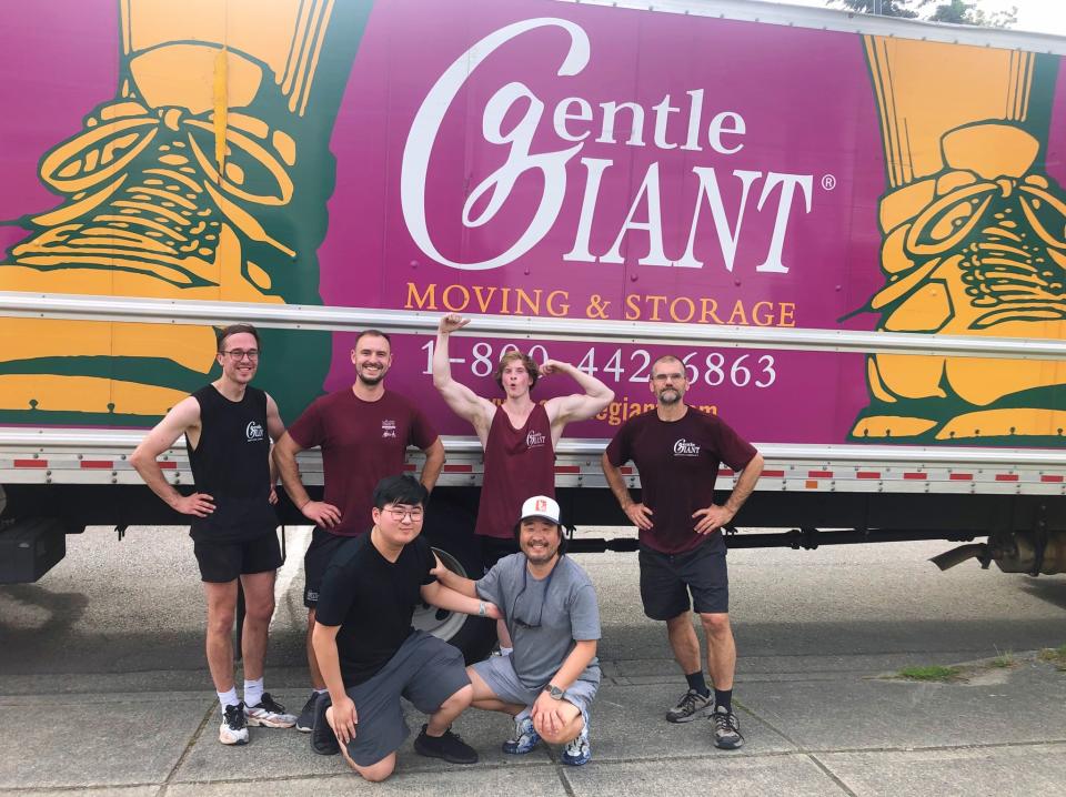 The Gentle Giant Moving & Storage crew pose for a photo by one of their trucks (Gentle Giant Moving)