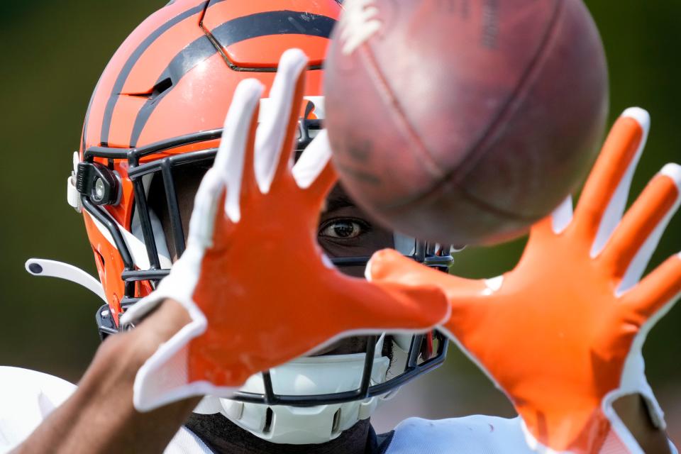 Cincinnati Bengals wide receiver Stanley Morgan (17) catches passes from the jug machine after a training camp practice at the Paycor Stadium practice facility in downtown Cincinnati on Tuesday, Aug. 1, 2023. Tuesday marked the team’s first preseason practice in pads.