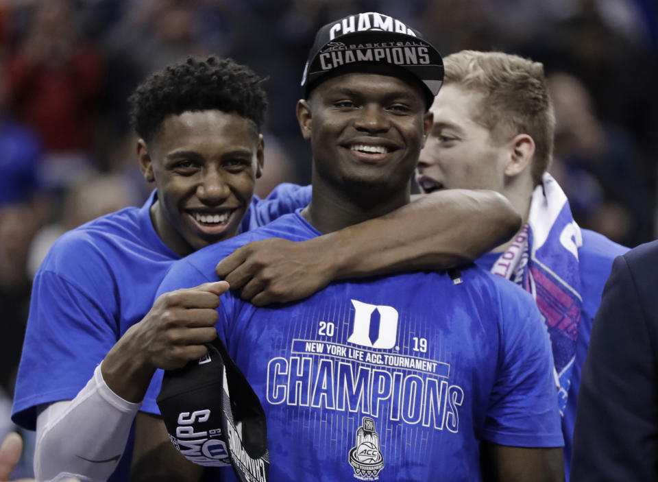Duke's RJ Barrett, left, hugs Zion Williamson after Duke defeated Florida State in the NCAA college basketball championship game of the Atlantic Coast Conference tournament in Charlotte, N.C., Saturday, March 16, 2019. (AP Photo/Chuck Burton)