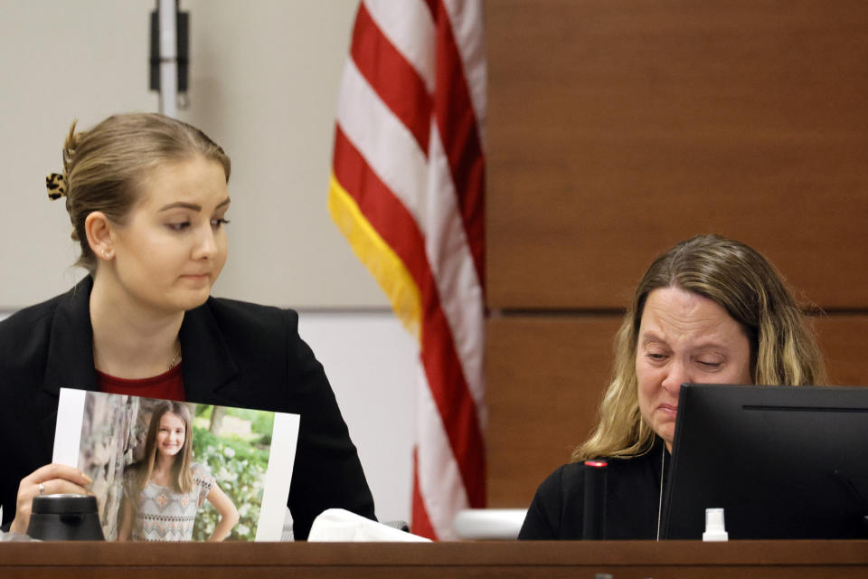 FILE - Meghan Petty comforts her mother, Kelly Petty, as she breaks down after being asked to identify her daughter in a photograph before giving her victim impact statement during the penalty phase of Marjory Stoneman Douglas High School shooter Nikolas Cruz's trial at the Broward County Courthouse in Fort Lauderdale, Fla., on Monday, Aug. 1, 2022. Petty's younger daughter, Alaina, was killed in the 2018 shootings. (Amy Beth Bennett/South Florida Sun Sentinel via AP, Pool, File)