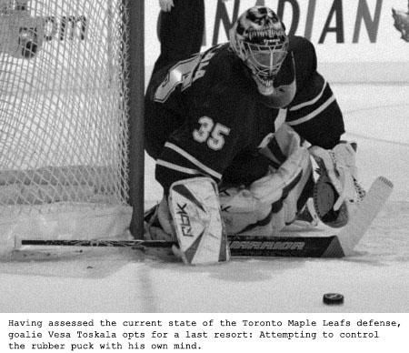 Toronto Maple Leafs goalie Vesa Toskala, left, wearing a