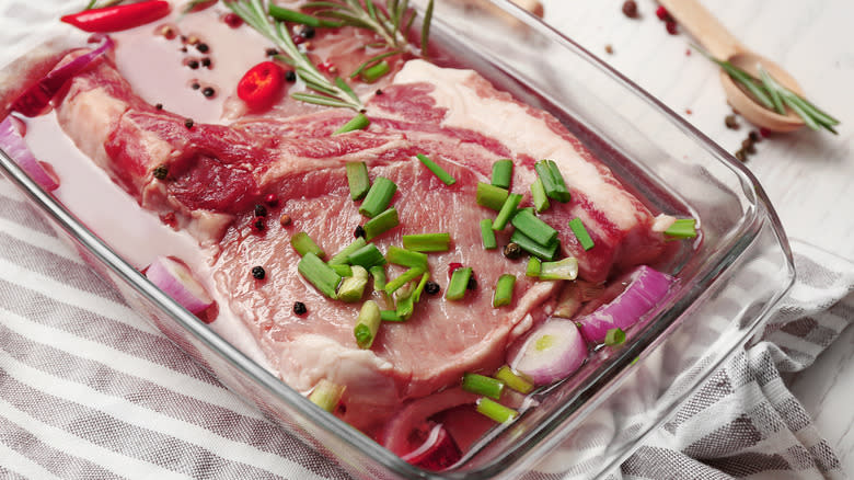 Steak marinading in glass pan 