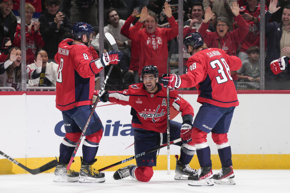 Washington Capitals right wing Tom Wilson, center, celebrates his goal against the Columbus Blue Jackets with left wing Alex Ovechkin (8) and defenseman Rasmus Sandin (38) during the first period of an NHL hockey game Saturday, Nov. 4, 2023, in Washington. (AP Photo/Jess Rapfogel)