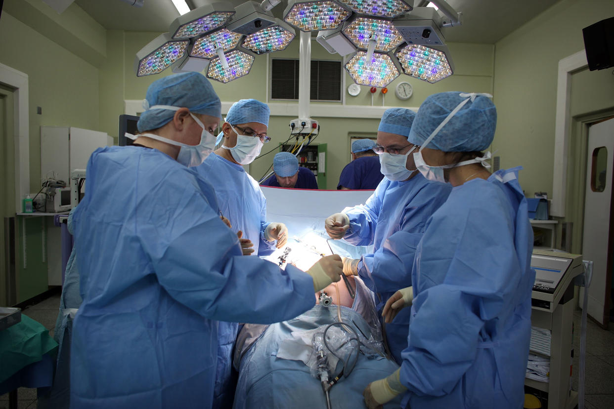 A surgeon and his theatre team perform key hole surgery. Photo: Getty