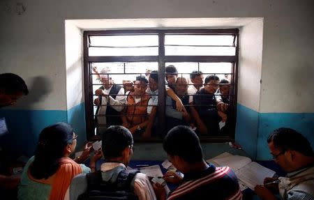 People collect their voters' identity cards at a polling station for the upcoming local election of municipalities and villages representatives in Thimi, Bhaktapur, Nepal, May 11, 2017. REUTERS/Navesh Chitrakar