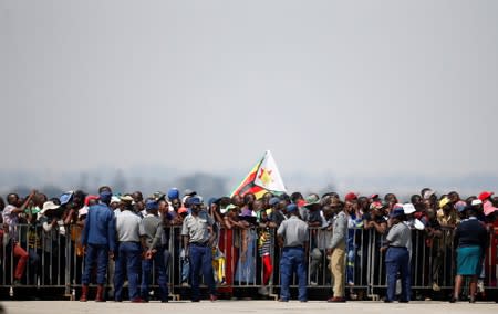 Zimbabweans wait for the arrival of the body of former Zimbabwean President Robert Mugabe to the country after he died on Friday (September 6) in Singapore after a long illness