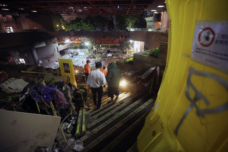 Protesters leave the campus of the Polytechnic University to surrender themselves to police in Hong Kong, Wednesday, Nov. 20, 2019. A small group of protesters refused to leave Hong Kong Polytechnic University, the remnants of hundreds who took over the campus for several days. They won't leave because they would face arrest. Police have set up a cordon around the area to prevent anyone from escaping. (AP Photo/Ahmad Ibrahim)