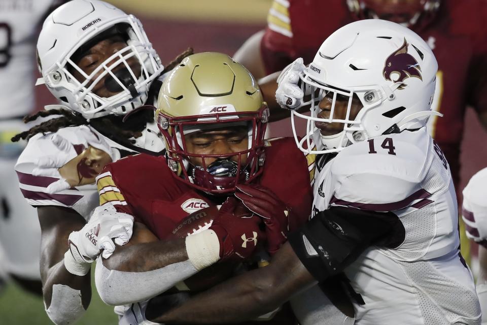 FILE - In this Sept. 26, 2020, file photo, Texas State linebacker Christian Taylor, left, and safety Tory Spears (14) tackle Boston College running back David Bailey during the first half of an NCAA college football game, in Boston. Texas State plkays ast BYU on Saturday, Oct. 24.(AP Photo/Michael Dwyer, File)