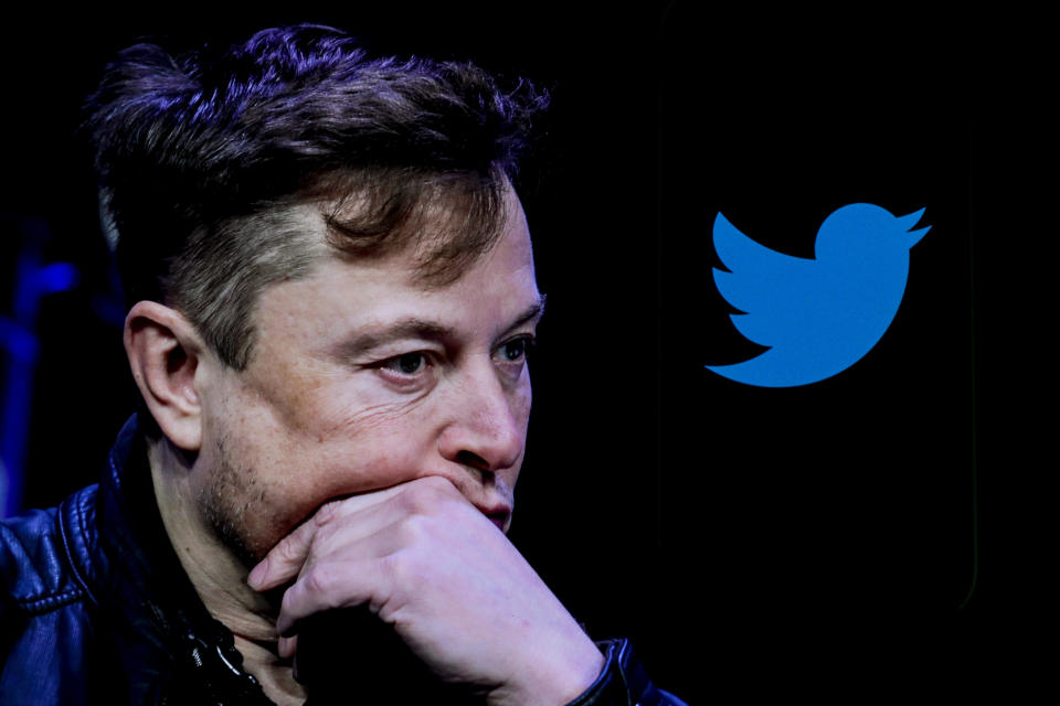 In this photo illustration, the image of Elon Musk is displayed on a computer screen and the logo of twitter on a mobile phone. / Credit: Muhammed Selim Korkutata / Anadolu Agency