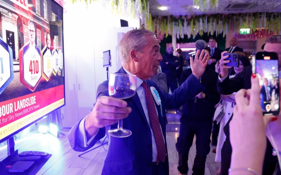 Nigel Farage toasts to the general election exit poll at an event with supporters in Clacton