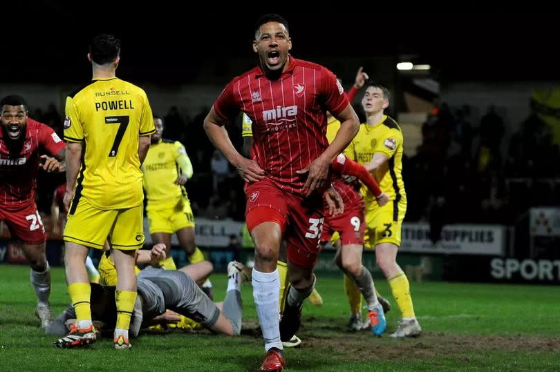 Curtis Davies celebrates his winner for Cheltenham Town at Burton Albion