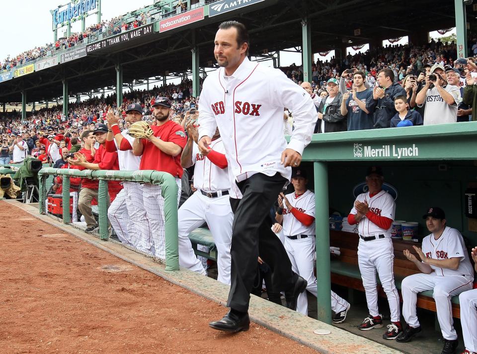 BOSTON, MA - MAY 15:  Former Red Sox pitcher Tim Wakefield runs out on to the field before the game against the Seattle Mariners on May 15, 2012 at Fenway Park in Boston, Massachusetts. Wakefield was honored in a pregame ceremony by the Boston Red Sox.  (Photo by Elsa/Getty Images)