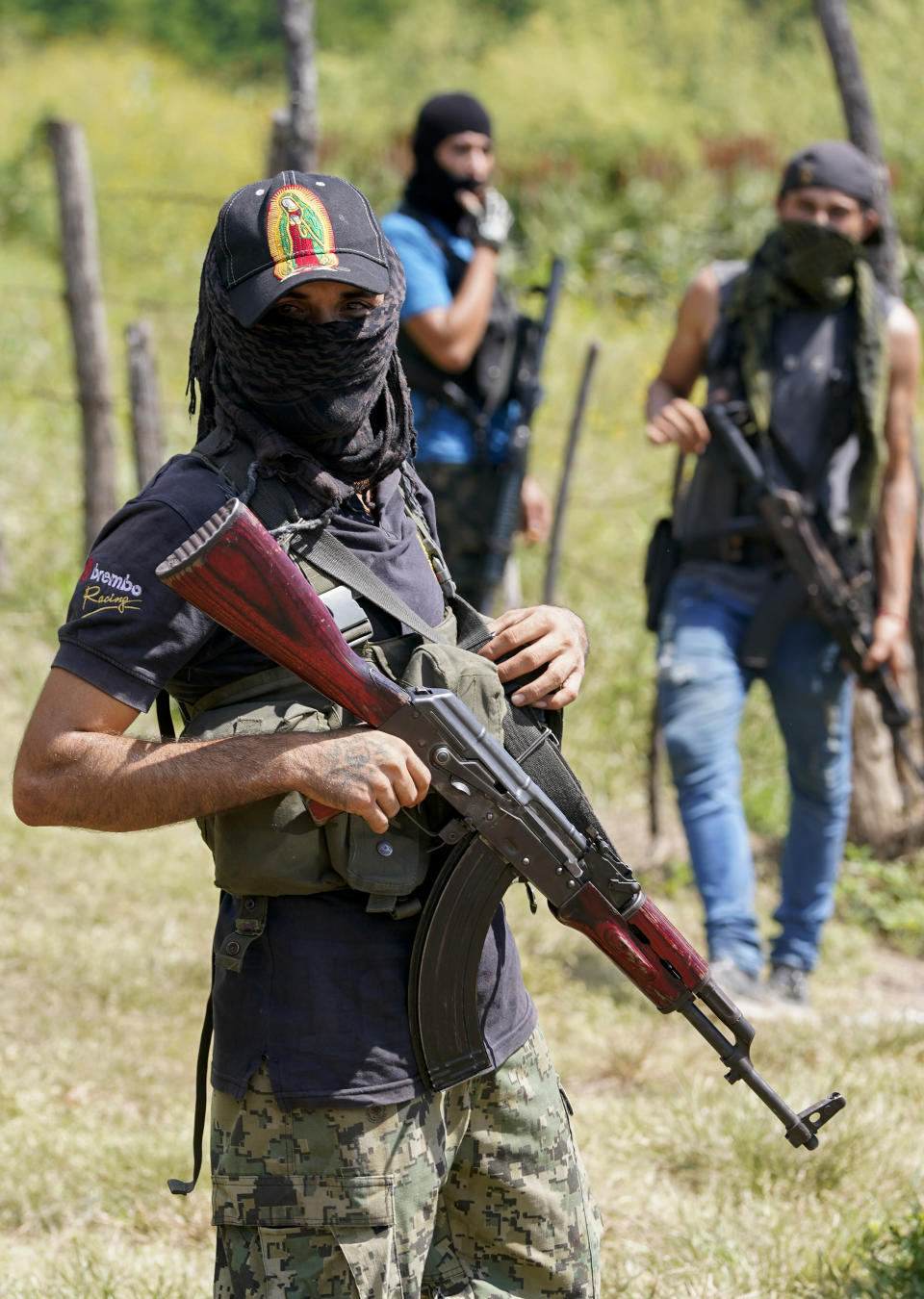 Armed men who claim to be members of a “self-defense” squad patrol the limits of Taixtan, in the Michoacan state of Mexico, Thursday, Oct. 28, 2021. The army has largely stopped fighting drug cartels here, instead ordering soldiers to guard the dividing lines between gang territories so they won’t invade each other’s turf _ and turn a blind eye to the cartels’ illegal activities. (AP Photo/Eduardo Verdugo)