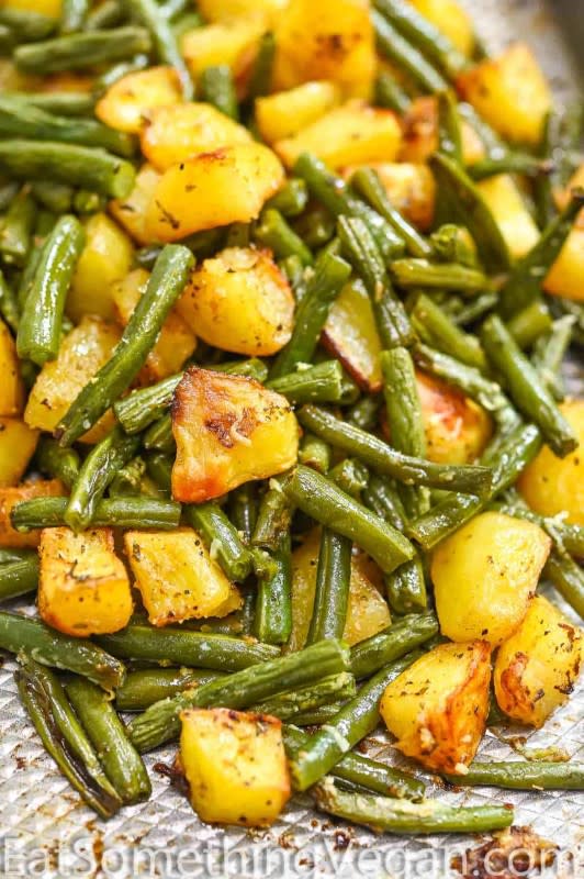 <p>Eat Something Vegan</p><p>These potatoes and green beans are a tasty side dish that you'll absolutely love. Made with garlic and flavorful seasonings, this oven-roasted veggie dish is delicious.</p><p><strong>Get the recipe: <a href="https://eatsomethingvegan.com/potatoes-and-green-beans/" rel="nofollow noopener" target="_blank" data-ylk="slk:Red Potatoes and Green Beans;elm:context_link;itc:0;sec:content-canvas" class="link rapid-noclick-resp">Red Potatoes and Green Beans</a></strong></p>