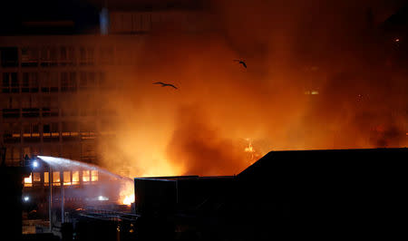 Firefighters attend to a blaze at the Mackintosh Building at the Glasgow School of Art, which is the second time in four years, Glasgow, Scotland, Britain, June 16, 2018. REUTERS/Russell Cheyne