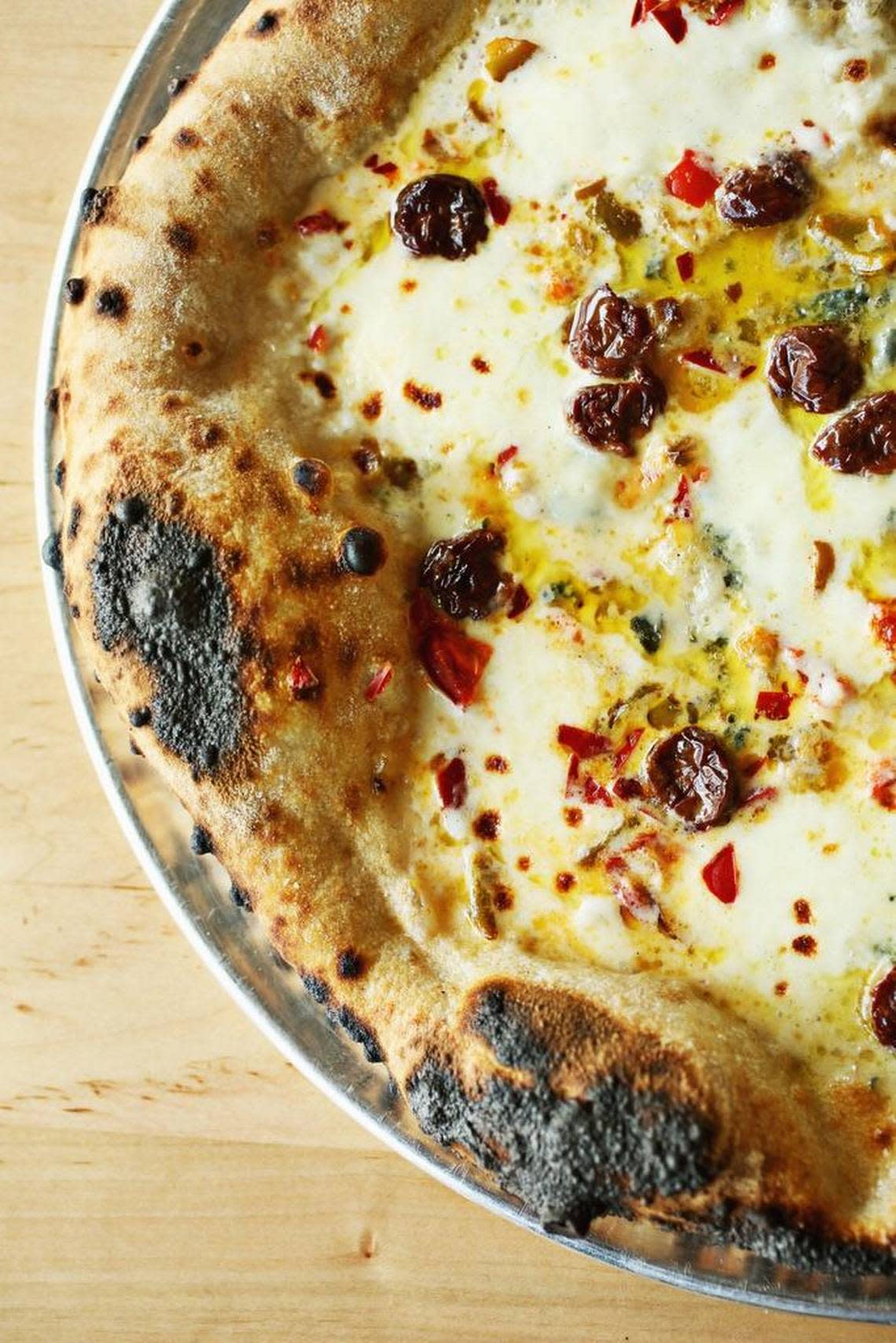 The Red White Blue pizza at Pizzeria Faulisi in Cary is made up of sour cherries, chilis, blue cheese and mozzarella. Toppings are first-rate and carefully applied with a generous hand (but not so generous as to overwhelm the crust).