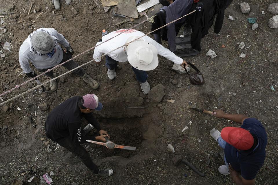 Relatives search for their missing loved ones in a clandestine grave in Zumpango, Mexico, Friday, April 19, 2024. Hundreds of collectives searching for missing loved ones fanned out across Mexico on Friday as part of a coordinated effort to raise the profile of efforts that are led by the families of the tens of thousands of missing across Mexico without support from the government. (AP Photo/Marco Ugarte)