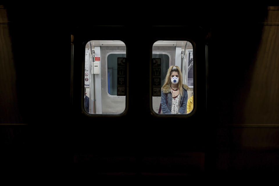 A commuter, wearing a mask as a preventive measure against the spread of the coronavirus, travels on a metro train in Istanbul, Friday, April 10, 2020.The new coronavirus causes mild or moderate symptoms for most people, but for some, especially older adults and people with existing health problems, it can cause more severe illness or death.(AP Photo/Emrah Gurel)